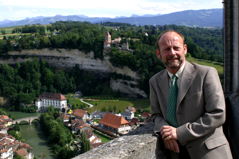 Dominique de Buman at the top of the frontal tower of St Nicolas Cathedral in Fribourg, from where we can contemplate the oldest Swiss old town and its districts of Bourg, Auge and Neuveville.